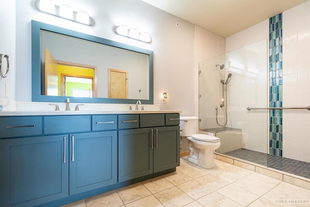 bathroom featuring a sink, tile patterned flooring, a tile shower, and toilet