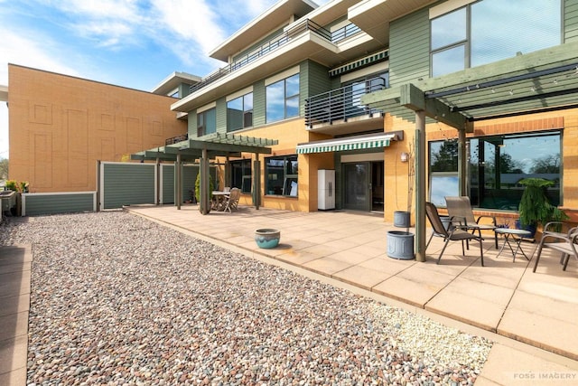 rear view of house with a pergola and a patio