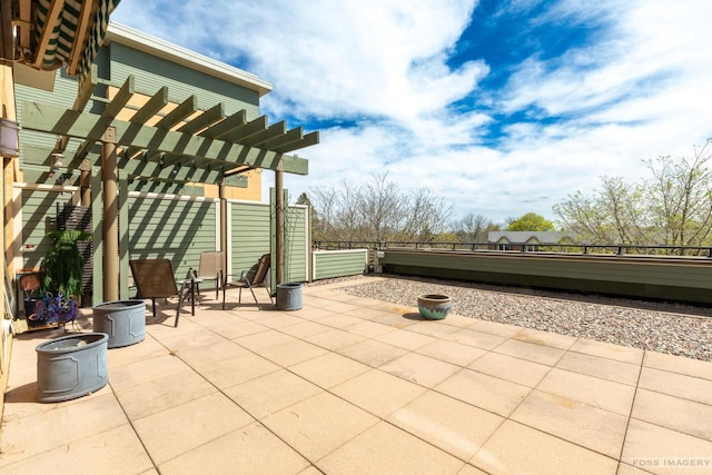 view of patio / terrace featuring fence and a pergola