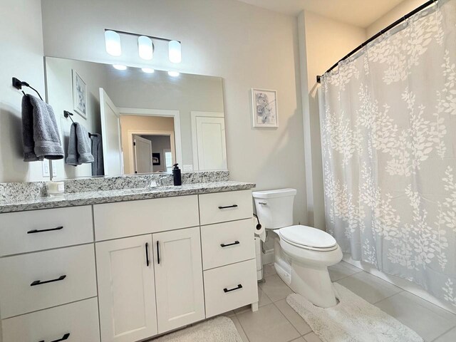full bathroom with vanity, tile patterned flooring, a shower with curtain, and toilet