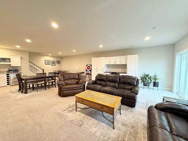 living room featuring stairway, indoor bar, and recessed lighting