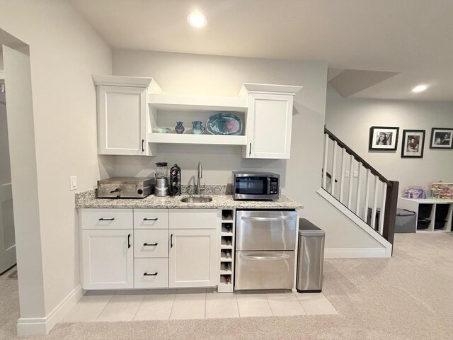 bar with a sink, appliances with stainless steel finishes, recessed lighting, and stairs