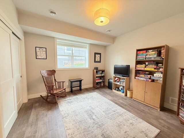 sitting room featuring baseboards and wood finished floors