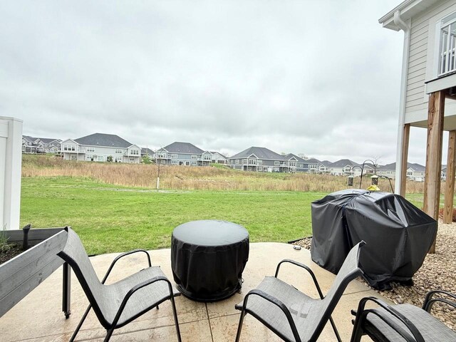 view of patio with a residential view and a grill