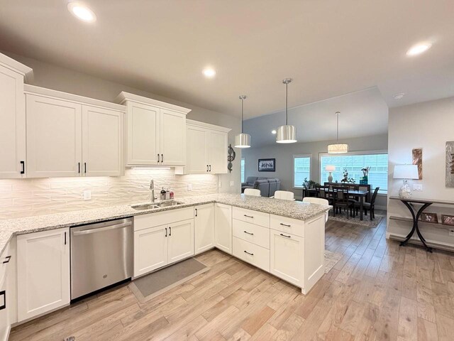 kitchen with a sink, light wood-style floors, white cabinetry, and dishwasher