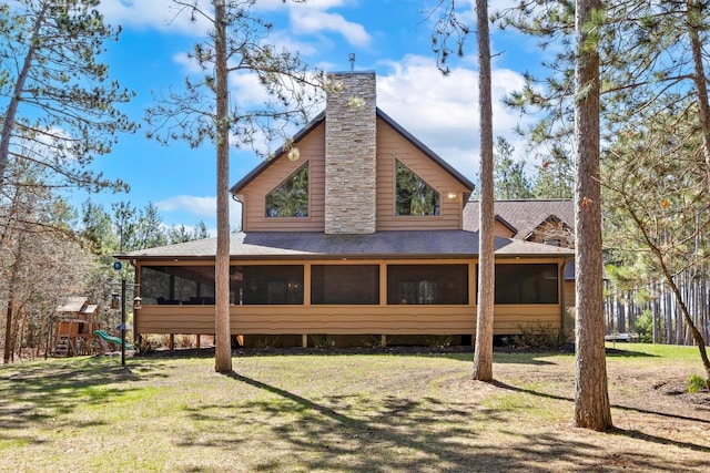 W5929 Driftwood Ln, New Lisbon, WI 53950 - back of house with a sunroom, a chimney, and roof with shingles