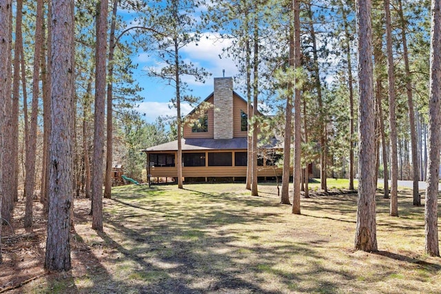 W5929 Driftwood Ln, New Lisbon, WI 53950 - view of front facade with a chimney, a playground, and roof with shingles