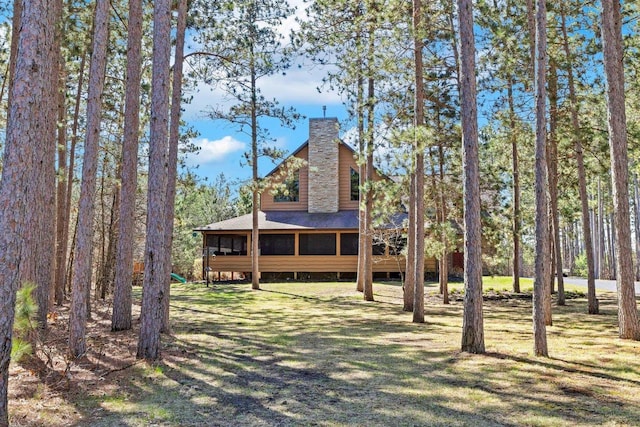 W5929 Driftwood Ln, New Lisbon, WI 53950 - view of front of home featuring a chimney, a sunroom, and a shingled roof