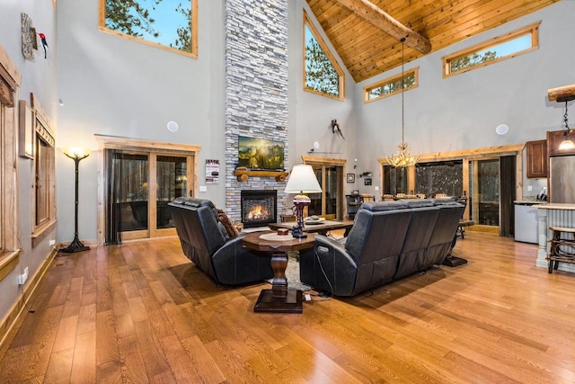 W5929 Driftwood Ln, New Lisbon, WI 53950 - living area featuring a fireplace, high vaulted ceiling, light wood-style floors, a wooden ceiling with exposed beams, and a chandelier