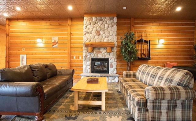 W5929 Driftwood Ln, New Lisbon, WI 53950 - living room with recessed lighting, a stone fireplace, and wooden walls
