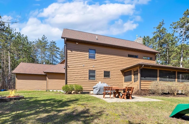 W5929 Driftwood Ln, New Lisbon, WI 53950 - rear view of house with an outdoor fire pit, a chimney, a sunroom, and a yard