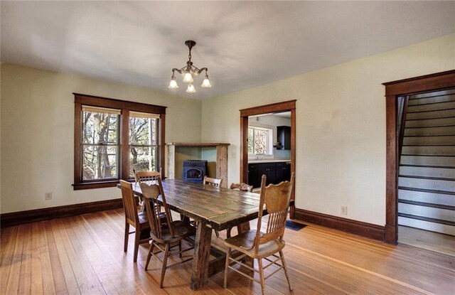 1725 Meadow Hill Dr, Menomonie, WI 54751 - dining space featuring baseboards, a notable chandelier, and light wood-style floors