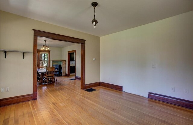 1725 Meadow Hill Dr, Menomonie, WI 54751 - spare room featuring baseboards, visible vents, light wood-style flooring, and a notable chandelier