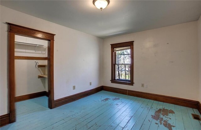 1725 Meadow Hill Dr, Menomonie, WI 54751 - unfurnished bedroom with baseboards, wood-type flooring, and visible vents