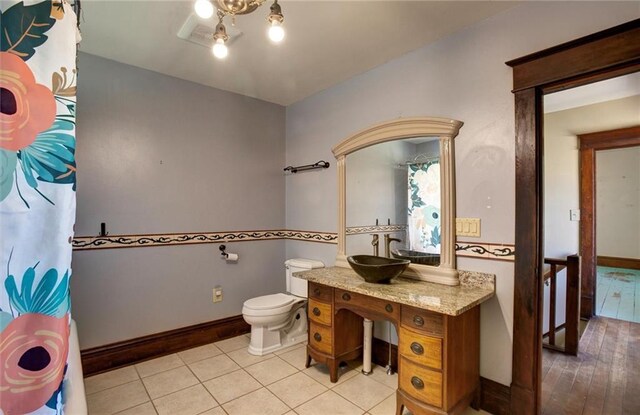 1725 Meadow Hill Dr, Menomonie, WI 54751 - full bath featuring vanity, baseboards, tile patterned floors, and toilet
