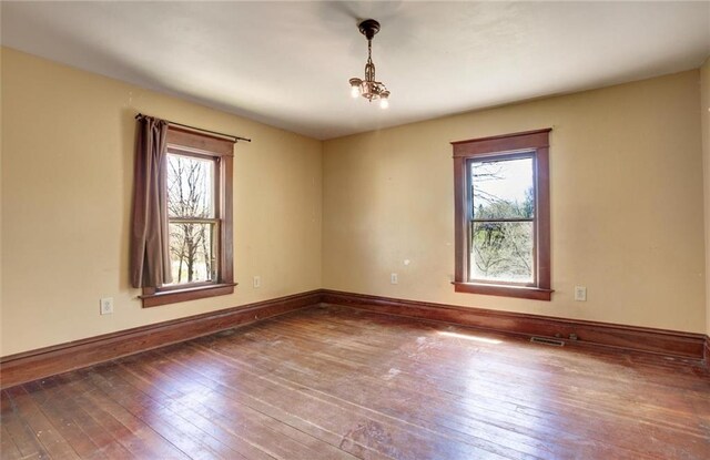1725 Meadow Hill Dr, Menomonie, WI 54751 - empty room featuring wood-type flooring, baseboards, and visible vents