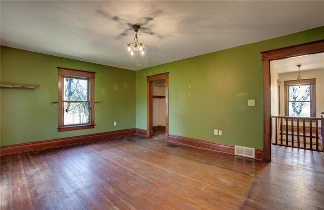 1725 Meadow Hill Dr, Menomonie, WI 54751 - unfurnished room featuring visible vents, baseboards, a chandelier, and a wealth of natural light