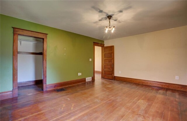 1725 Meadow Hill Dr, Menomonie, WI 54751 - unfurnished bedroom with visible vents, a ceiling fan, baseboards, and wood finished floors