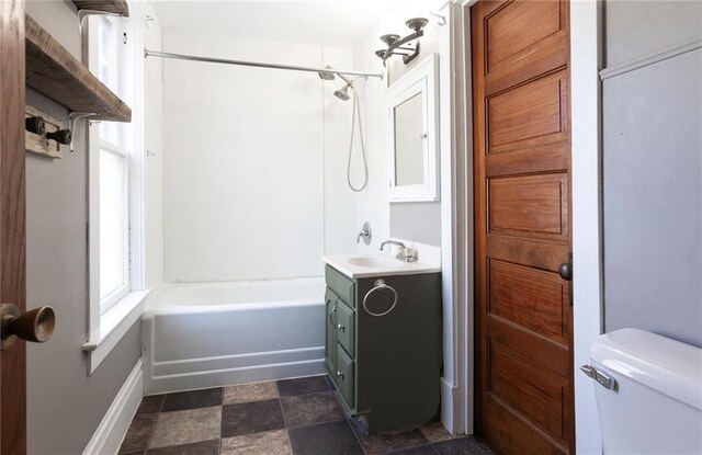 1725 Meadow Hill Dr, Menomonie, WI 54751 - bathroom featuring vanity, stone finish floor, toilet, and shower / washtub combination