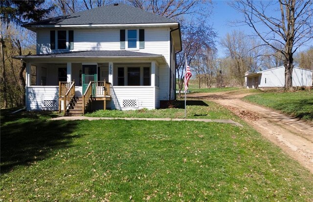 1725 Meadow Hill Dr, Menomonie, WI 54751 - american foursquare style home with dirt driveway, a porch, a front lawn, and stairway