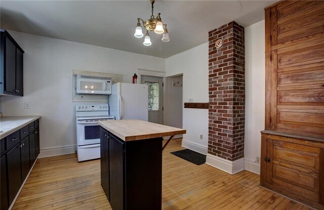 1725 Meadow Hill Dr, Menomonie, WI 54751 - kitchen with baseboards, light wood finished floors, an inviting chandelier, white appliances, and butcher block countertops