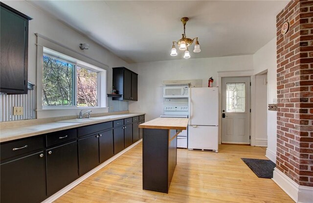 1725 Meadow Hill Dr, Menomonie, WI 54751 - kitchen featuring a sink, light wood-type flooring, wooden counters, and white appliances