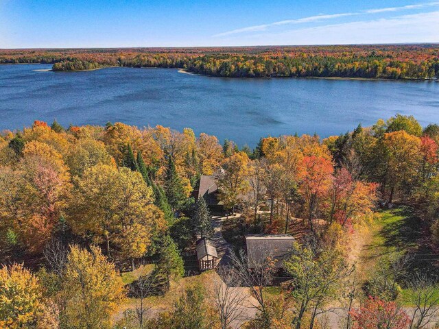 aerial view of a nearby body of water and a heavily wooded area