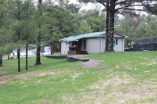 ranch-style house featuring metal roof and a front yard