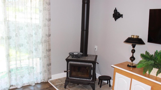 room details featuring baseboards and a wood stove
