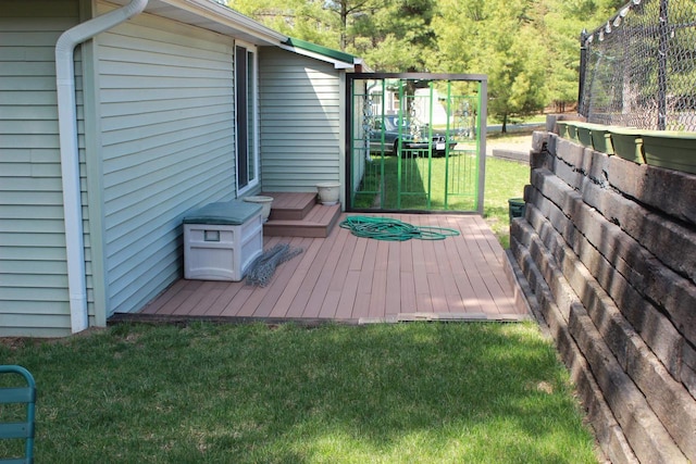 wooden deck with a lawn and fence