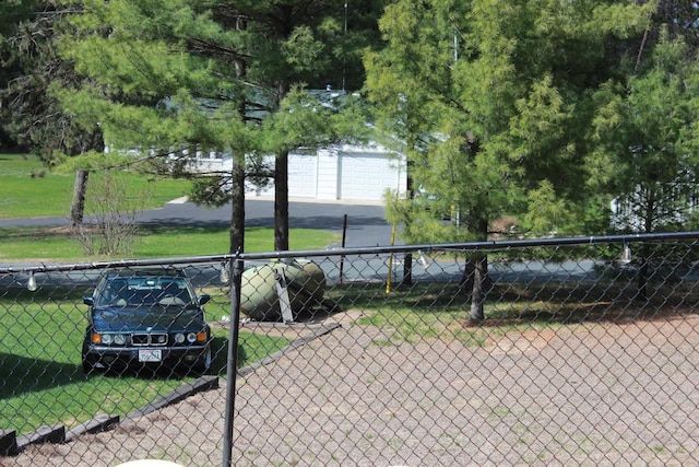 view of property's community with a lawn and fence