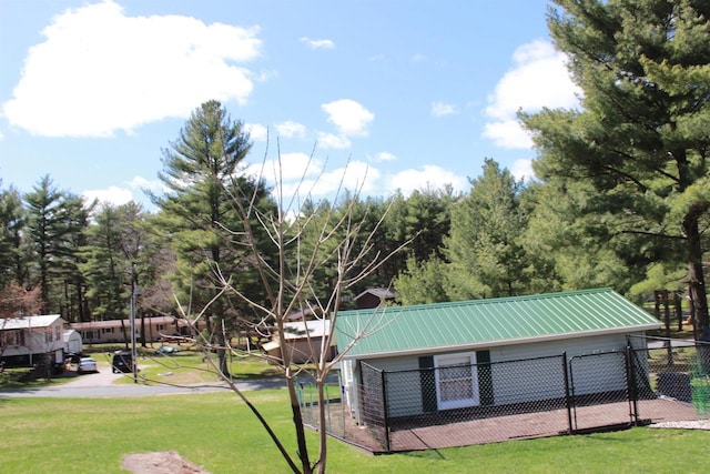 view of community with fence and a yard