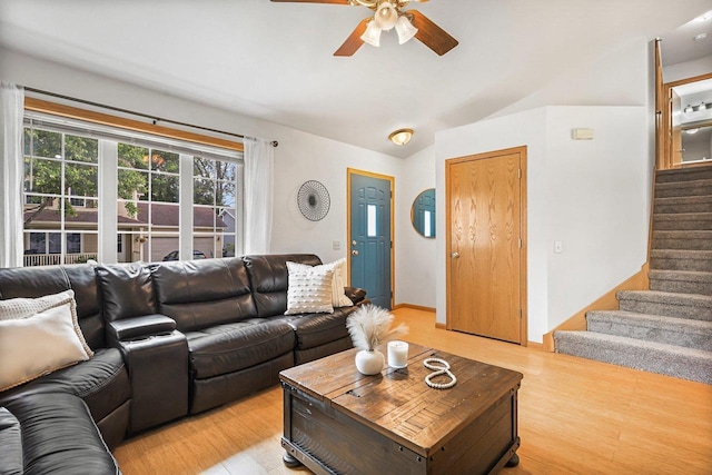 3631 Flagstone Cir, Middleton, WI 53562 - living area featuring vaulted ceiling, ceiling fan, stairway, and light wood-style flooring