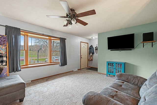 living room with visible vents, a ceiling fan, carpet, and baseboards