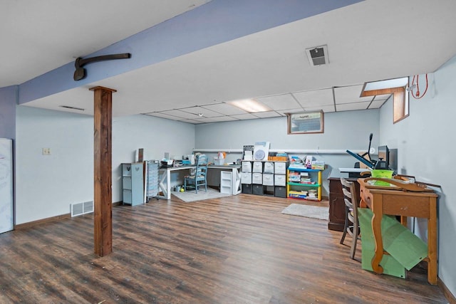 home office featuring baseboards, a drop ceiling, wood finished floors, and visible vents