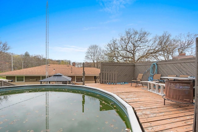 pool with a gazebo and a deck