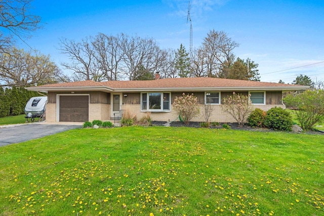 ranch-style home with brick siding, aphalt driveway, a front lawn, and a garage