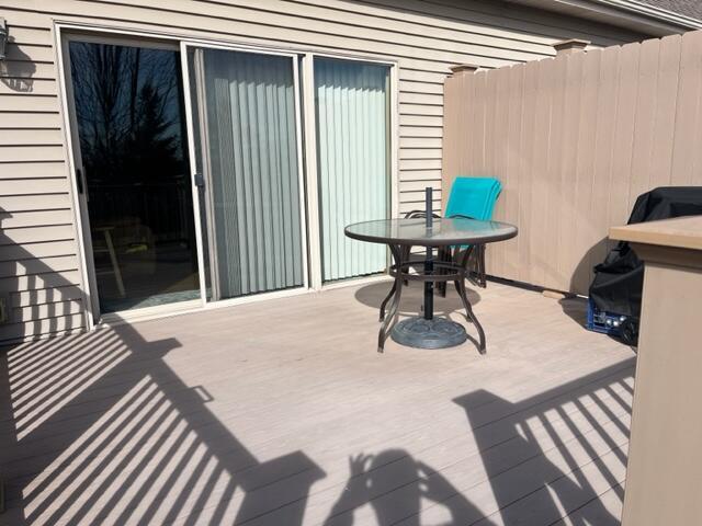 view of patio featuring fence and a deck