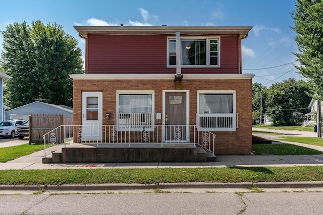 view of front of property with covered porch and fence