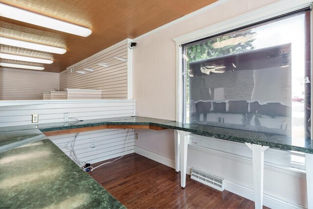 interior space featuring crown molding, dark wood finished floors, and visible vents