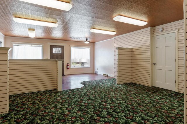unfurnished room featuring carpet floors, baseboards, and visible vents