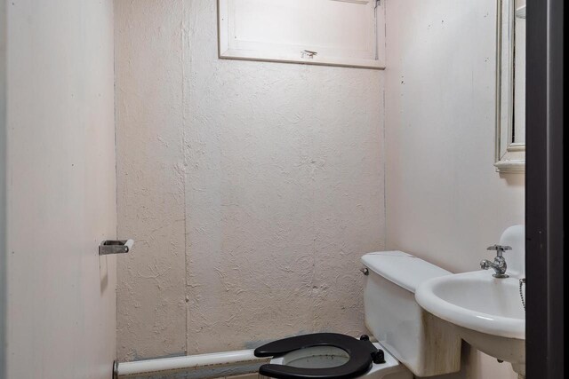 half bath with a sink and toilet