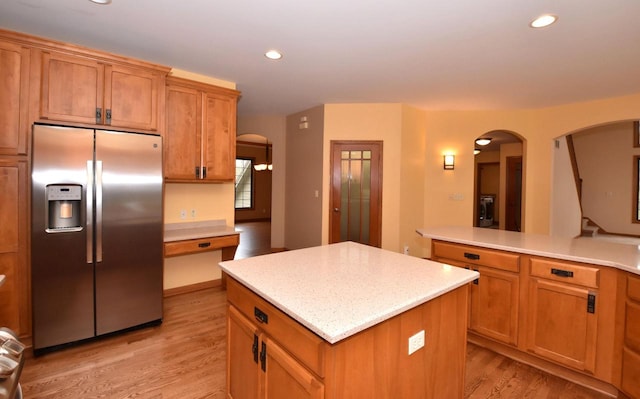 765 Safer Ct, Brookfield, WI 53045 - kitchen featuring stainless steel fridge with ice dispenser, light wood-type flooring, a center island, and arched walkways