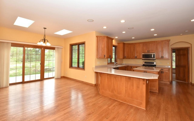 765 Safer Ct, Brookfield, WI 53045 - kitchen featuring a skylight, stainless steel appliances, light countertops, and plenty of natural light