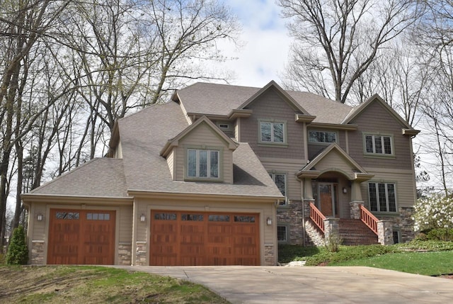 765 Safer Ct, Brookfield, WI 53045 - craftsman-style house with concrete driveway, stone siding, roof with shingles, and an attached garage