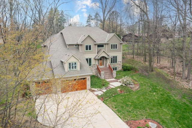 765 Safer Ct, Brookfield, WI 53045 - view of front facade with stone siding, a garage, a shingled roof, a front yard, and driveway