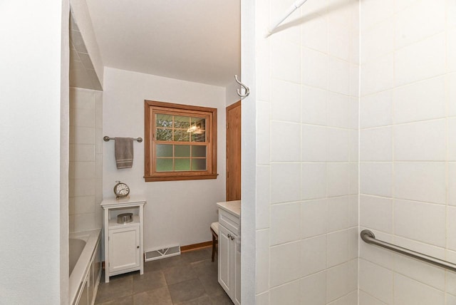 full bath with visible vents, walk in shower, a bathing tub, baseboards, and tile patterned floors