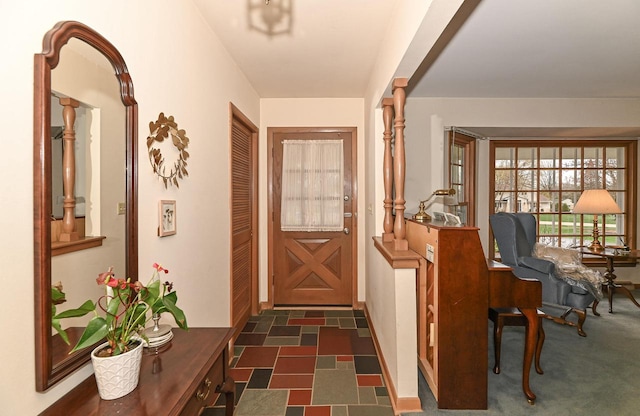 doorway to outside featuring baseboards