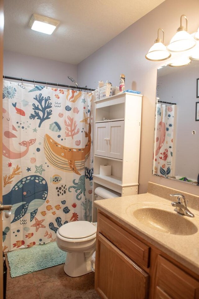 2193 Julie Ave, Sparta, WI 54656 - bathroom with toilet, a shower with shower curtain, tile patterned flooring, and vanity