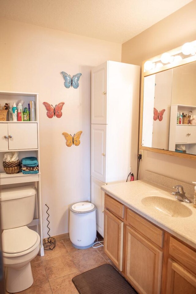 2193 Julie Ave, Sparta, WI 54656 - bathroom with vanity, baseboards, tile patterned flooring, and toilet
